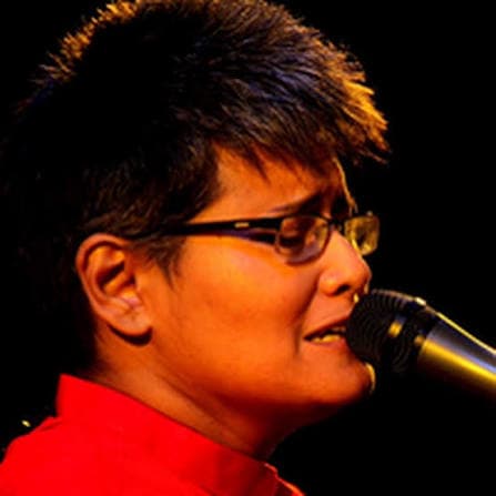 Close-up of Farzana Wahid Shayan singing into a microphone